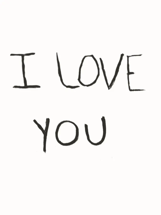 A short handwritten note reading I love you, in charcoal on white